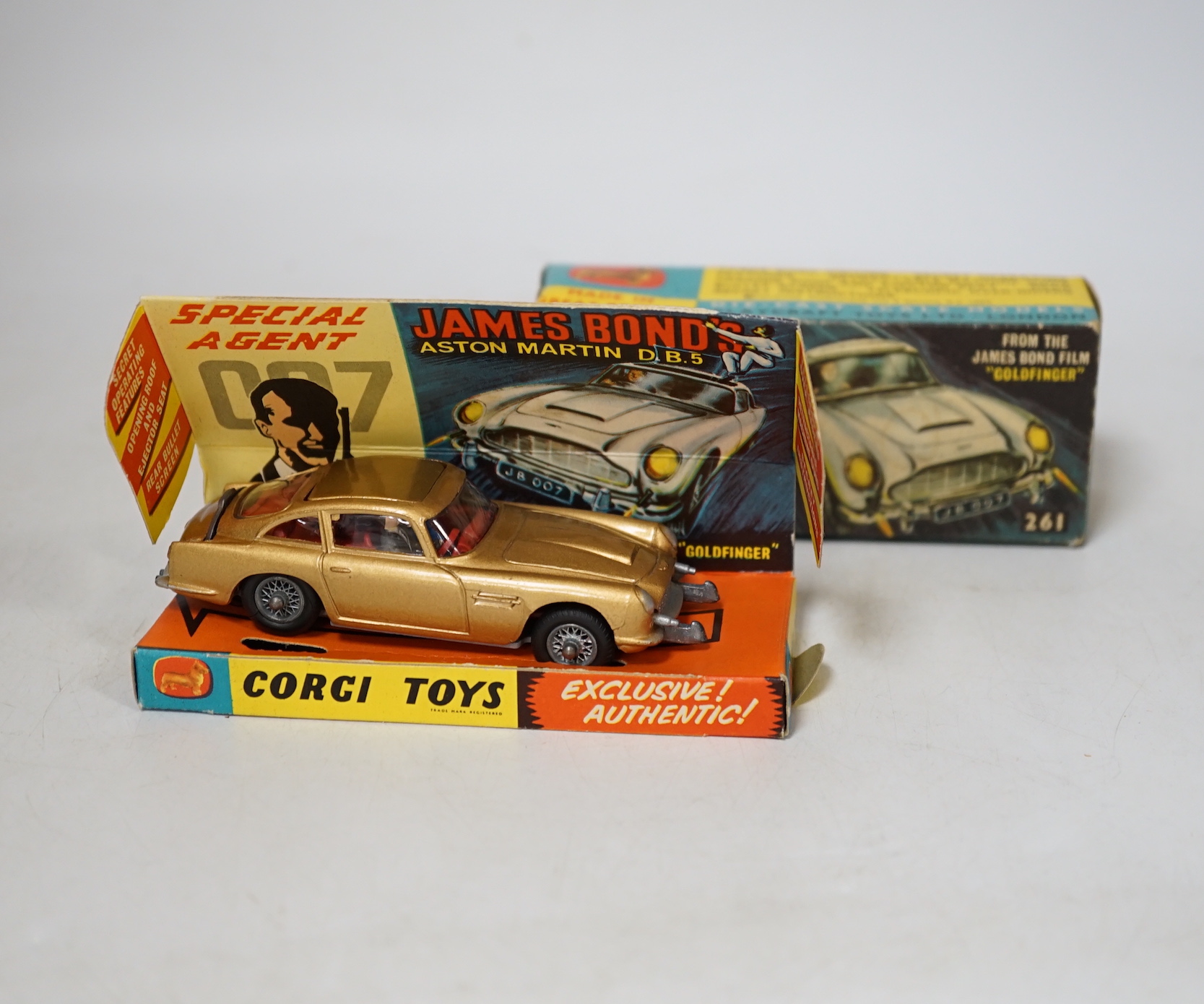 Corgi Toys James Bond's Aston Martin (261) in gold, boxed with driver, passenger, inner display tray, correct leaflet advertising other Corgi models and a ‘Secret Instructions’ envelope containing instructions and unused